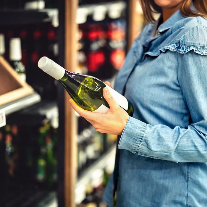 Customer buying white wine or sparkling drink.