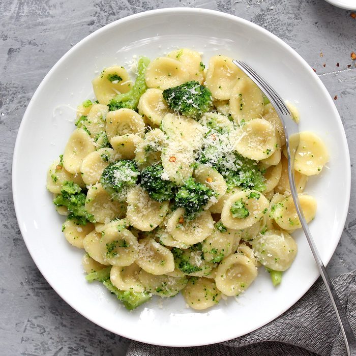 Homemade pasta orecchiette with broccoli, Parmesan cheese and chili pepper on light background. Top view with copy space.; Shutterstock ID 1309385296