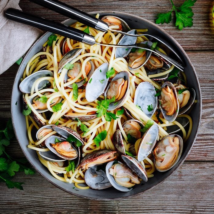 Traditional italian seafood pasta with clams Spaghetti alle Vongole in the pan on wooden background; Shutterstock ID 1319109386; Job (TFH, TOH, RD, BNB, CWM, CM): Taste of Home
