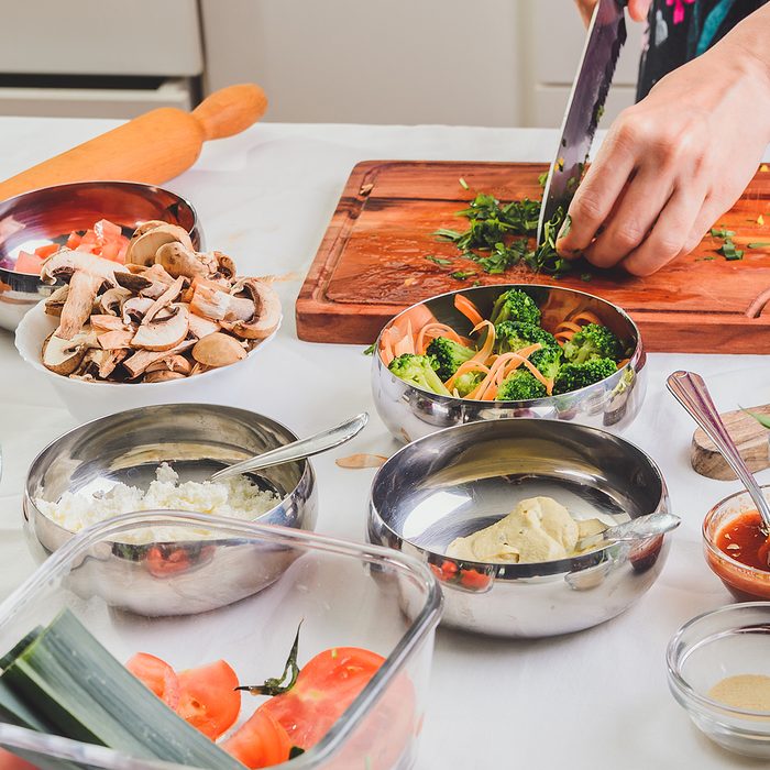 Female hands chopping vegetables, preparing ingredients for a delicious meal; Shutterstock ID 1394301821; Job (TFH, TOH, RD, BNB, CWM, CM): TOH