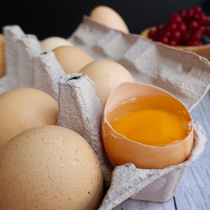 ingredients for baking lie on a light wooden background with a blue kitchen towel. flour, eggs, butter, berries, a bun and wooden tools; Shutterstock ID 1503991832; Job (TFH, TOH, RD, BNB, CWM, CM): TOH