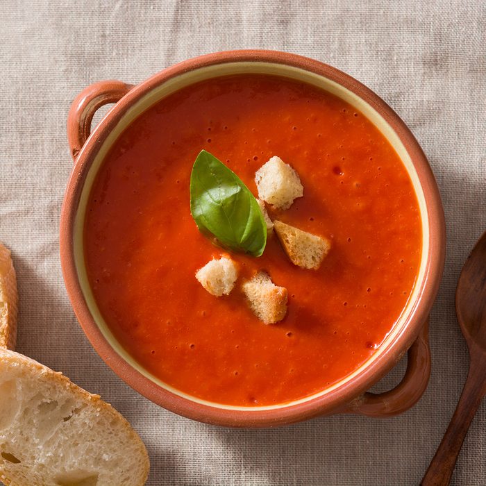 Tomato soup in brown bowl on wooden table. Top view; Shutterstock ID 1515744377; Job (TFH, TOH, RD, BNB, CWM, CM): TOH