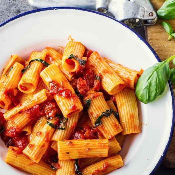 Pasta Rigatoni with tomato sauce basil leaves garlic and parmesan cheese.; Shutterstock ID 396666679; Job (TFH, TOH, RD, BNB, CWM, CM): Taste of Home