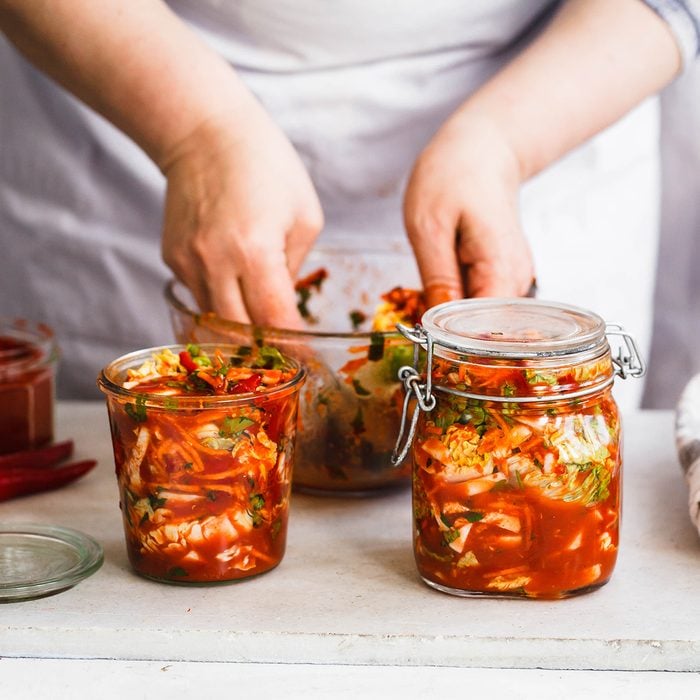 Base Cabbage Kimchi. Person preparing cabbage kimchi. Fermented and vegetarian preserved food concept.; Shutterstock ID 621832271