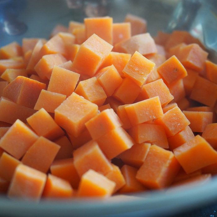 Orange Sweet Potato cut into small cubic shapes and boiled in hot water to soften the texture; Shutterstock ID 1318952024; Job (TFH, TOH, RD, BNB, CWM, CM): TOH