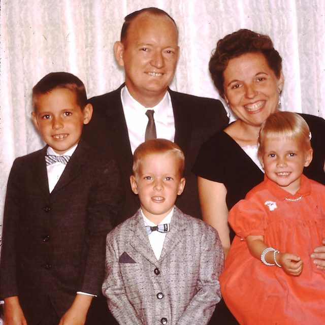 A father and mother pose with their three children 1960s