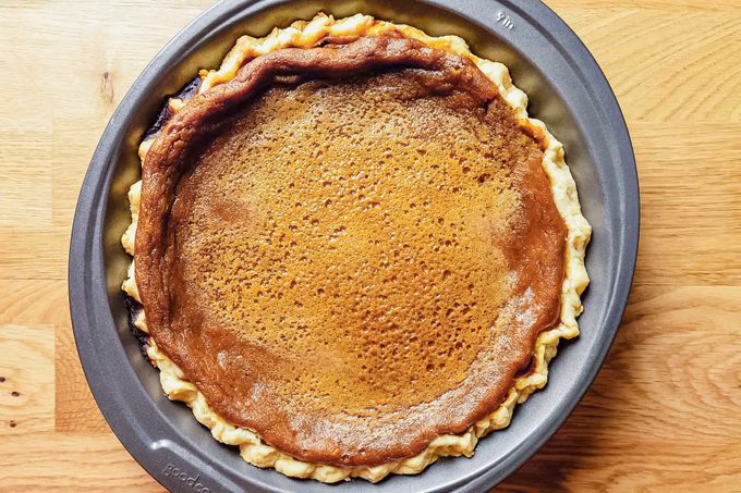 Dairy Free Pumpkin Pie in a Baking Plate on Wooden Surface