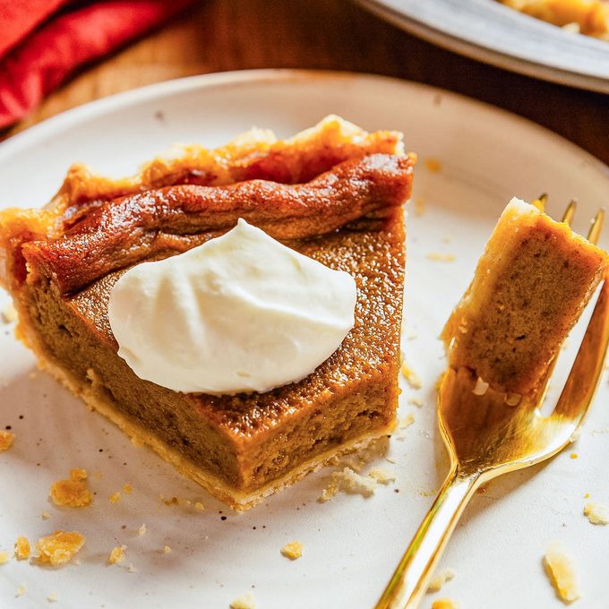Dairy Free Pumpkin Pie Served in a White Plate with Golden Fork