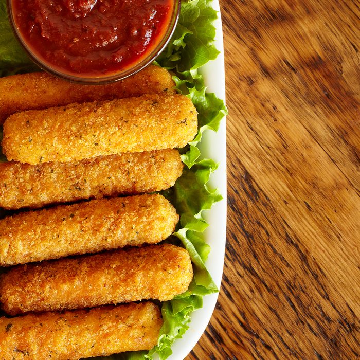 "Mozzarella sticks with marinara dipping sauce on bed of lettuce. Space for copy. Professionally color corrected, exported 16 bit depth, retouched and saved for maximum image quality.Please see other appetizer images from my portfolio:"