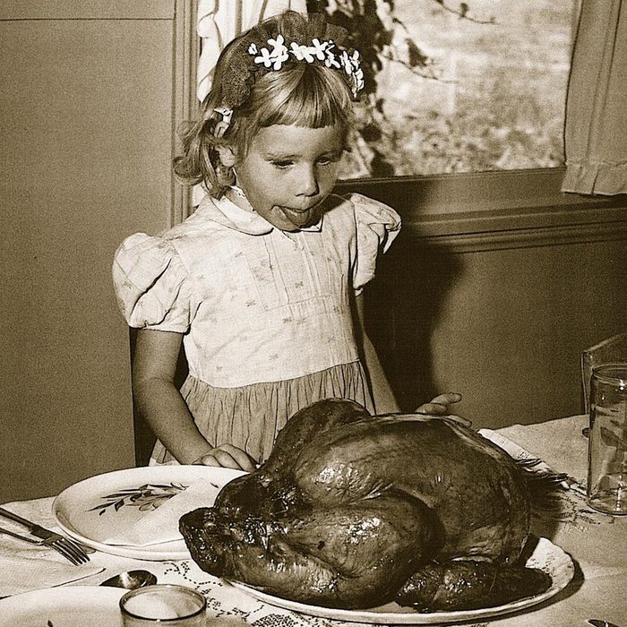 little 1950s girl stares at turney with her tongue out