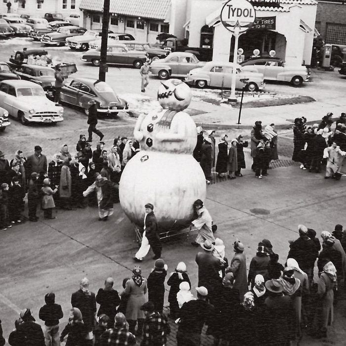 snowman float being wheeled down street during thanksgiving parade in Sheboygan Wi 1950s