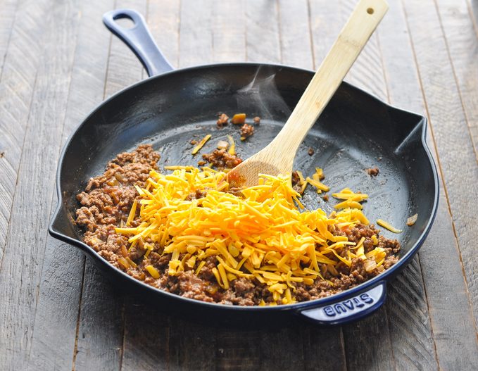 Cheese on top of browned ground beef