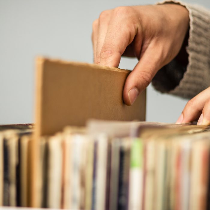 Close up on hands browsing record store