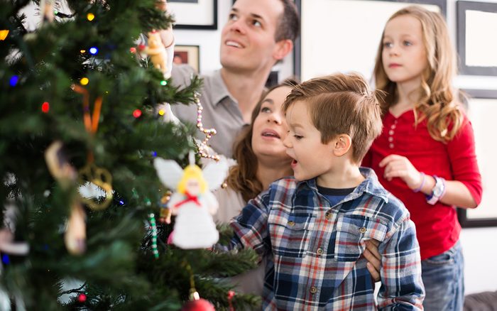 Family of four preparing for Christmas together at home