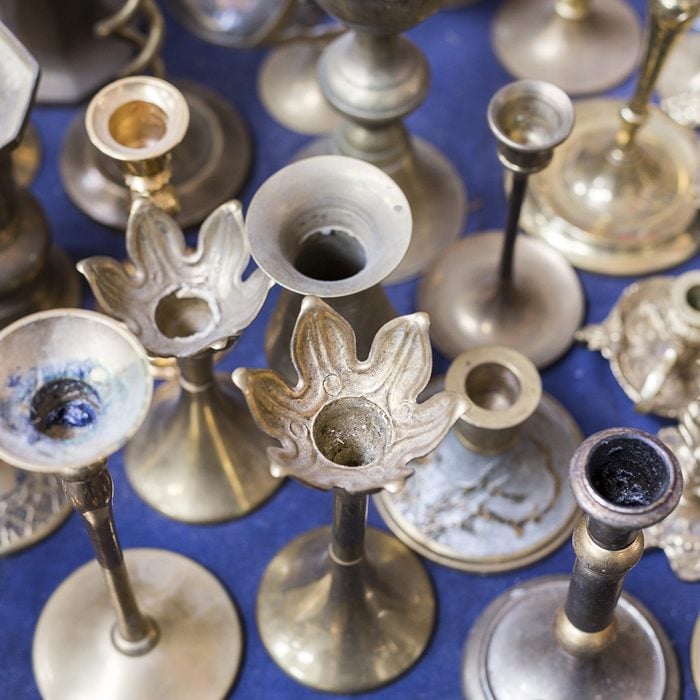 many old silver candle-stands on a flea market