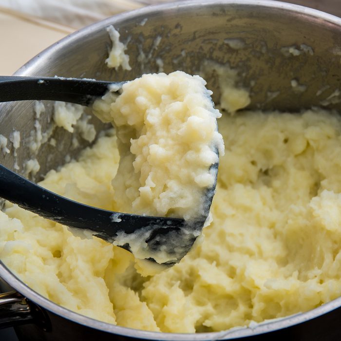 Cooking boiled potatoes in the mashed potatoes in a metal pan; Shutterstock ID 1061454149; Job (TFH, TOH, RD, BNB, CWM, CM): TOH