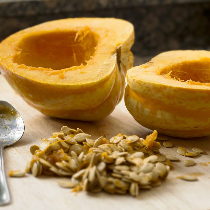 Winter squash cut in half with spoon and seeds scooped out.; Shutterstock ID 175357406; Job (TFH, TOH, RD, BNB, CWM, CM): TOH