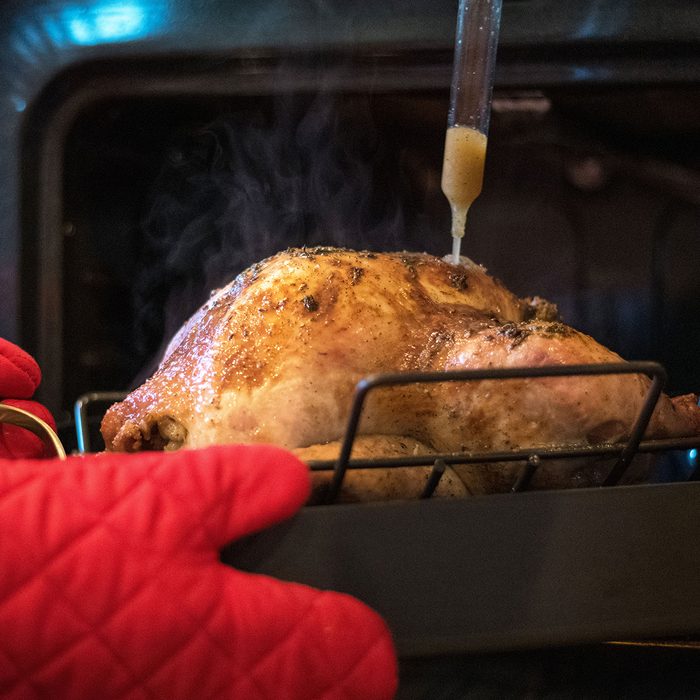 Using baster on turkey coming out of the oven