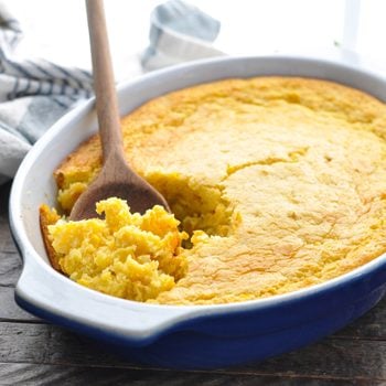 Easy Corn Casserole in a dish with a wooden spoon