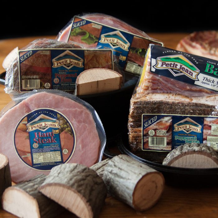 Petit Jean Meat brand ackages of pork on table with wood