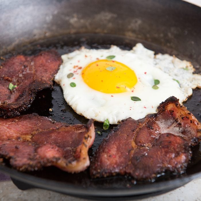 Back Shoulder Bacon Cooked in Cast Iron Skillet with Fresh Egg