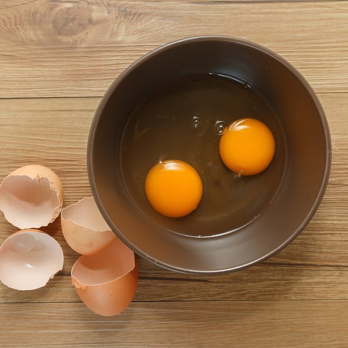 Cracked eggs with yolks in a bowl