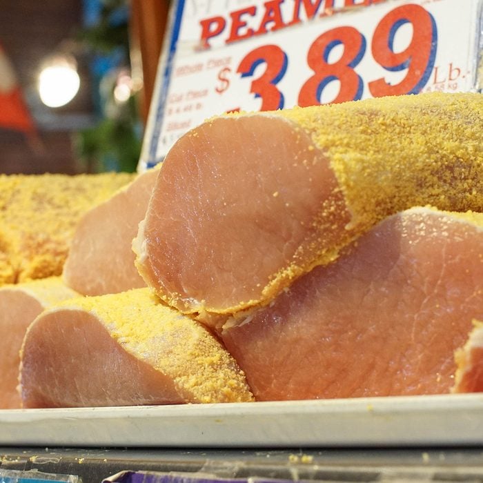 fresh slabs of Peameal bacon on a tray at the supermarket, also known as Canadian bacon