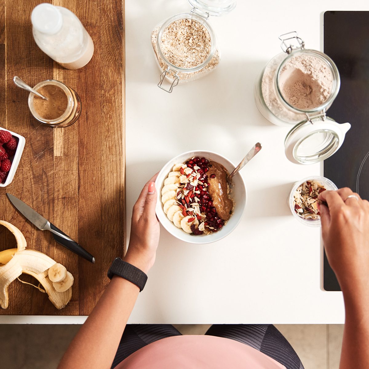 Overhead Shot Of Woman Preparing Healthy Breakfast At Home After Exercise