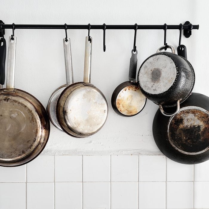 Pots and pans hanging on a kitchen wall