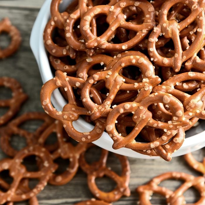 Hard Pretzels or Salted pretzels snack for party in white bowl on wooden floor