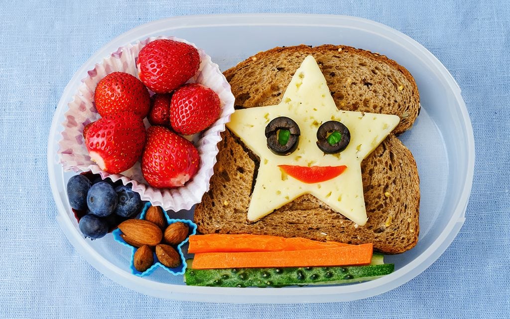 school lunch box for kids with food in the form of funny faces. the toning.