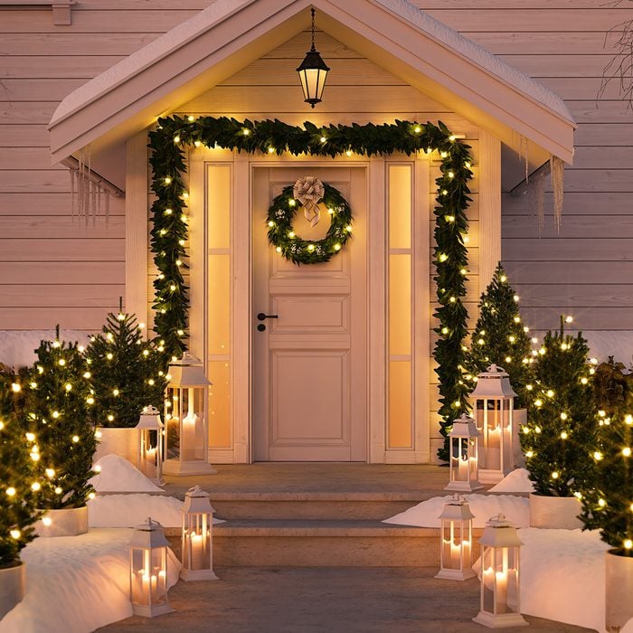 3d rendering. christmas decorated porch with little trees and lanterns.