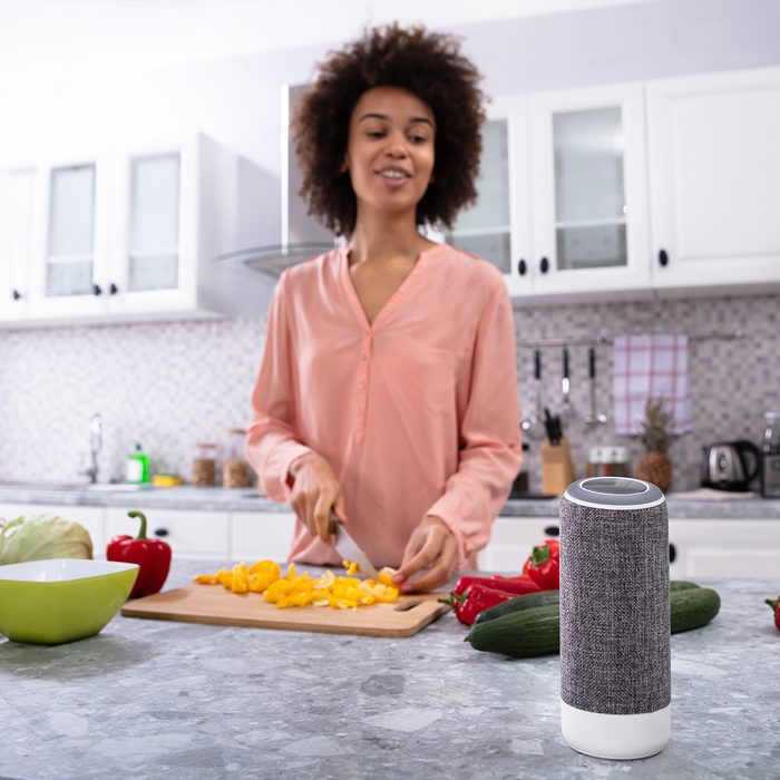 kitchens get smart, 2020 food trends, Wireless Speaker In Front Of Woman Cutting Vegetables On Chopping Board In The Kitchen; Shutterstock ID 1282479844; Job (TFH, TOH, RD, BNB, CWM, CM): Taste of Home