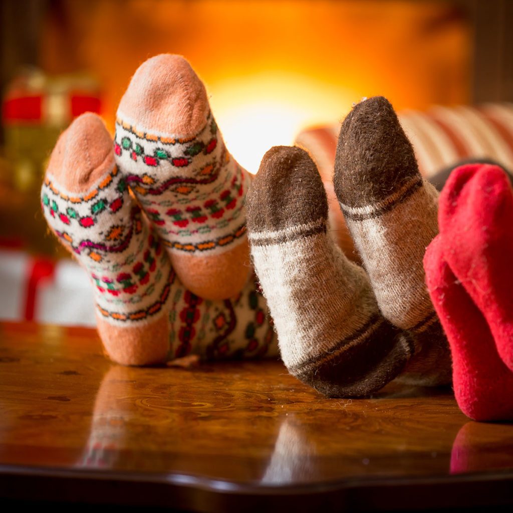 Closeup photo of family feet in wool socks at fireplace; Shutterstock ID 328810142; Job (TFH, TOH, RD, BNB, CWM, CM): TOH