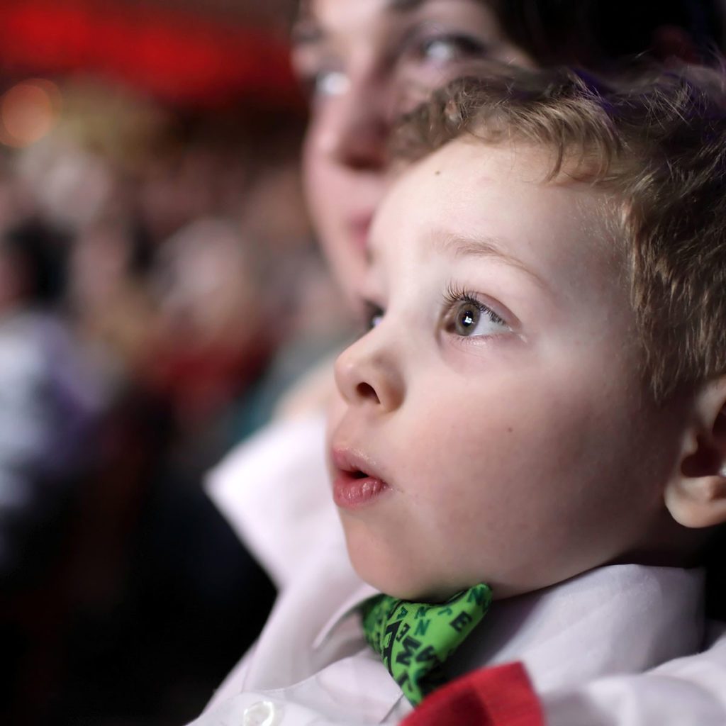 Portrait of astonished child at a circus; Shutterstock ID 512155558