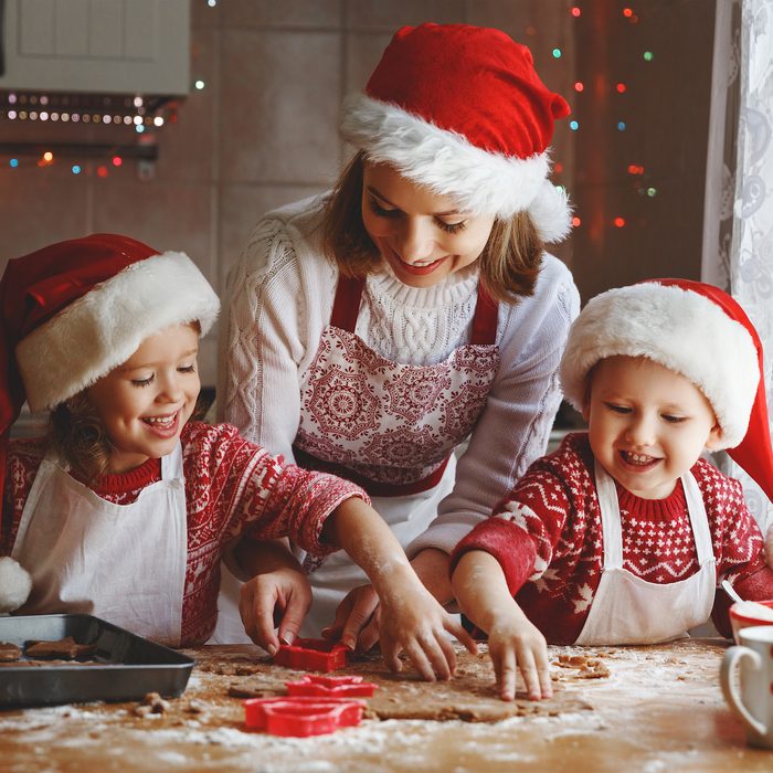 happy family mother and children son and daughter bake cookies for Christmas