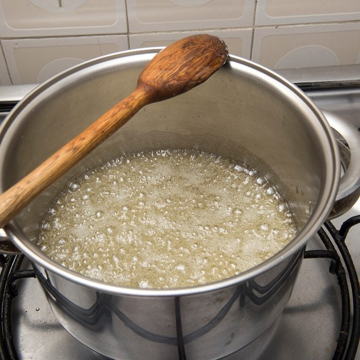 sugar syrup being made in a pan on the stove