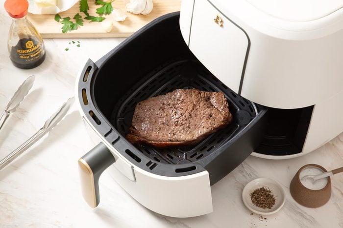 A Piece of Meat in a Small White and Black Fryer