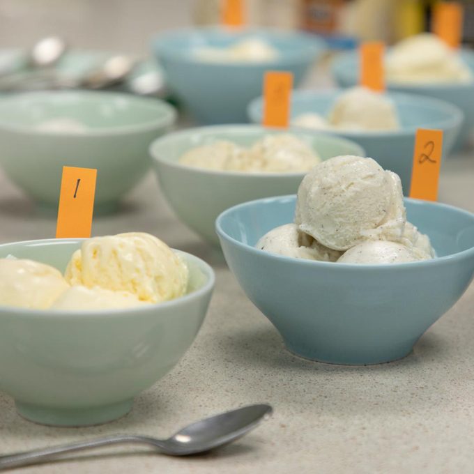 Several blue bowls of icecream marked with orange strips of paper