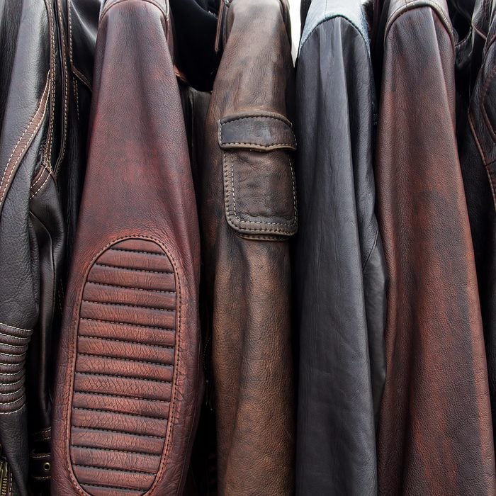 Collection of leather jackets on hangers in the shop.