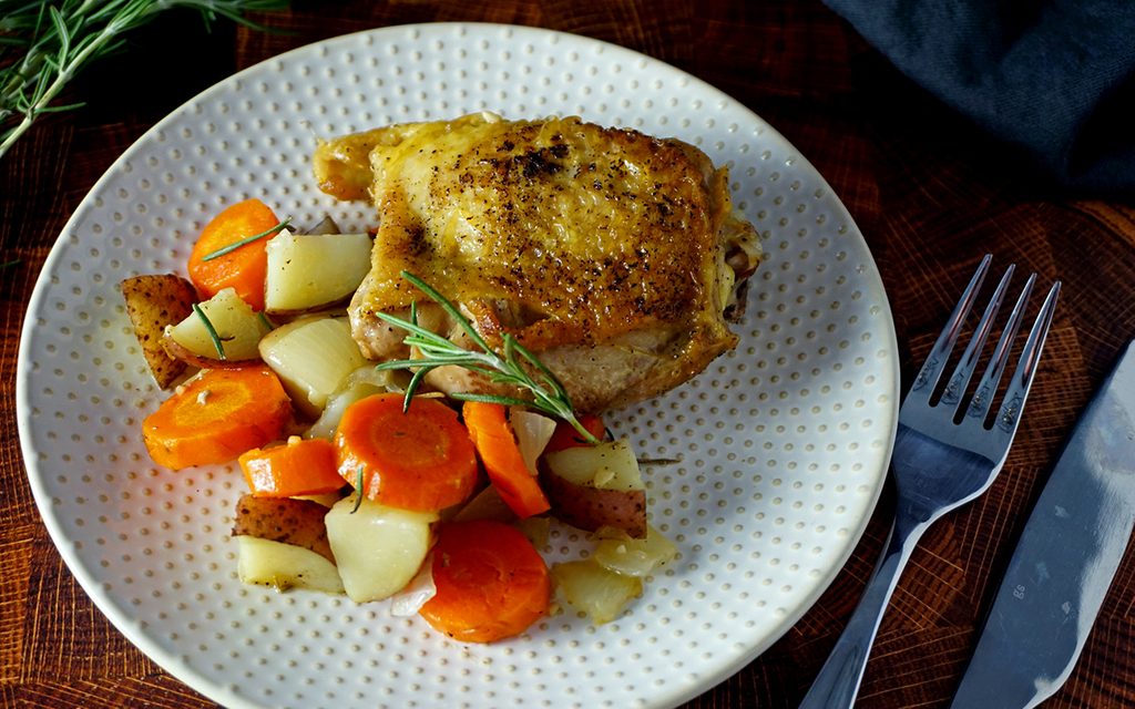 Dutch oven chicken thigh and vegetables on a plate