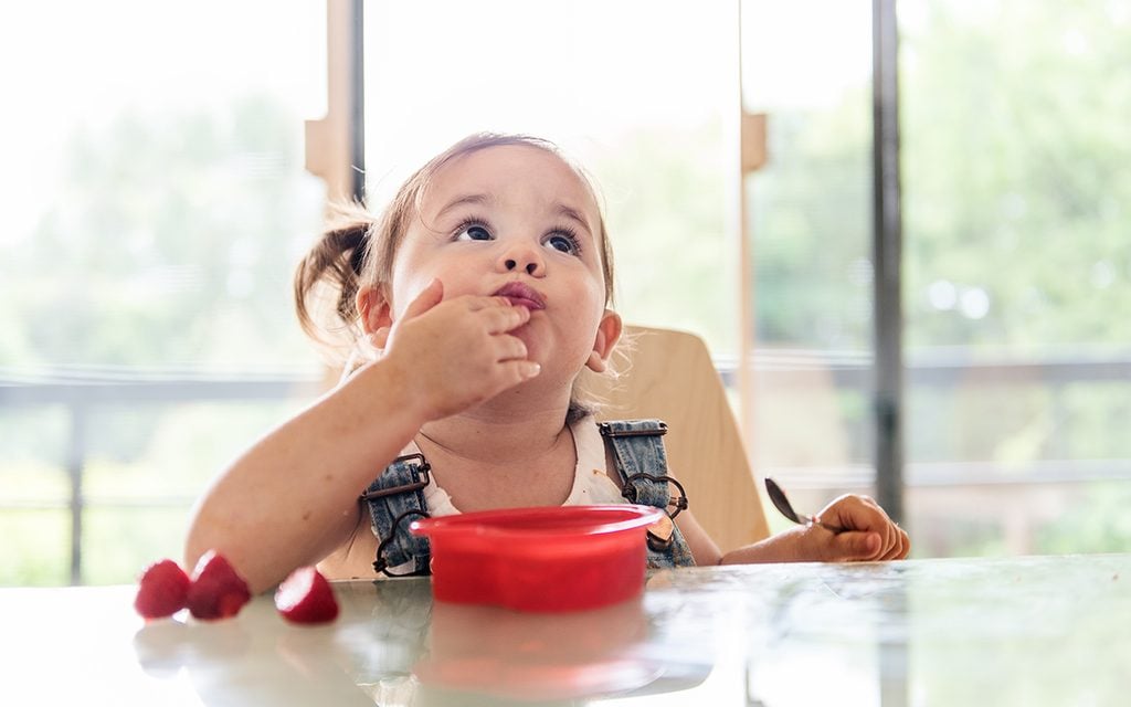 Little 2 years old girl eating jello