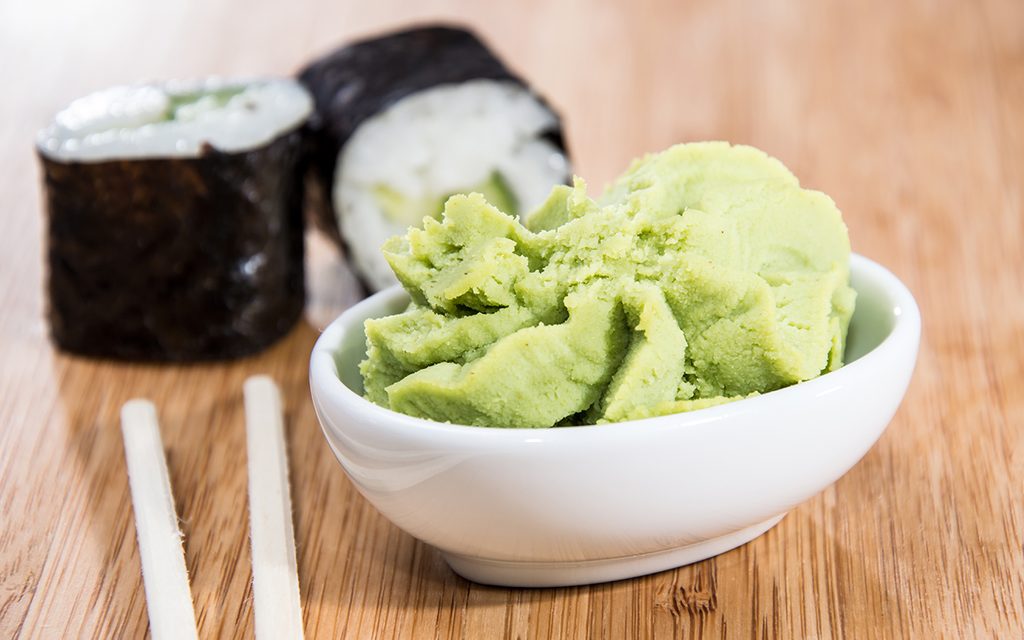 Maki rolls with Wasabi on wooden background