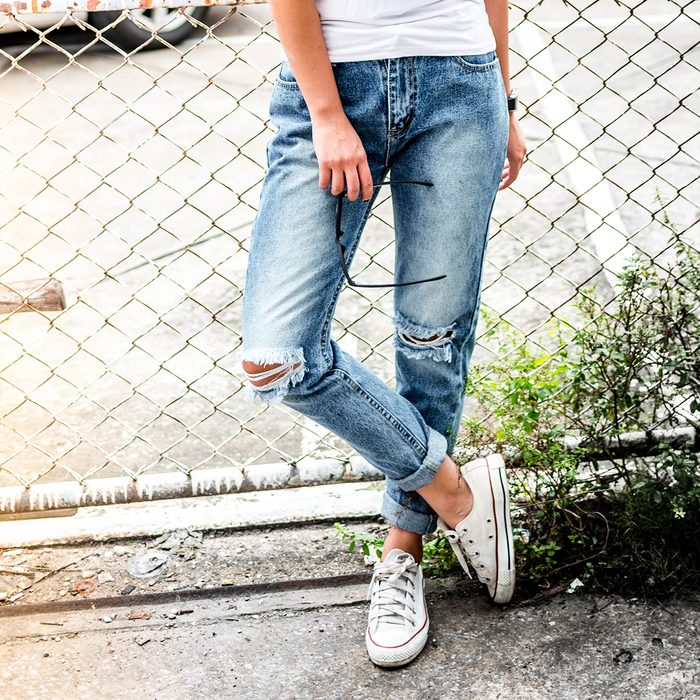 woman in fashionable ripped Jeans