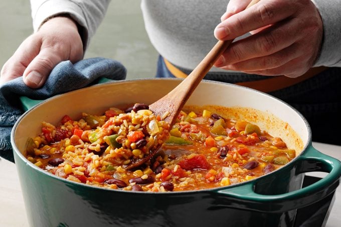 anonymous person stirring taste of home's vegan chili