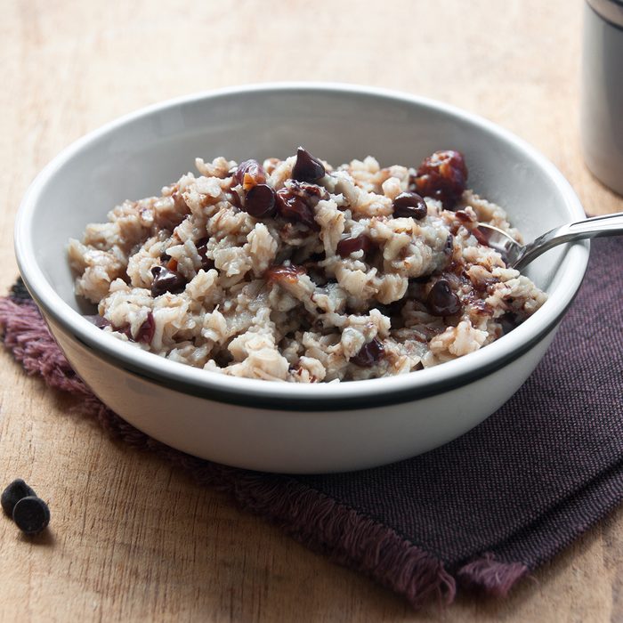 A bowl of oatmeal with dried sour cherries and chocolate chips awaits the morning diner.