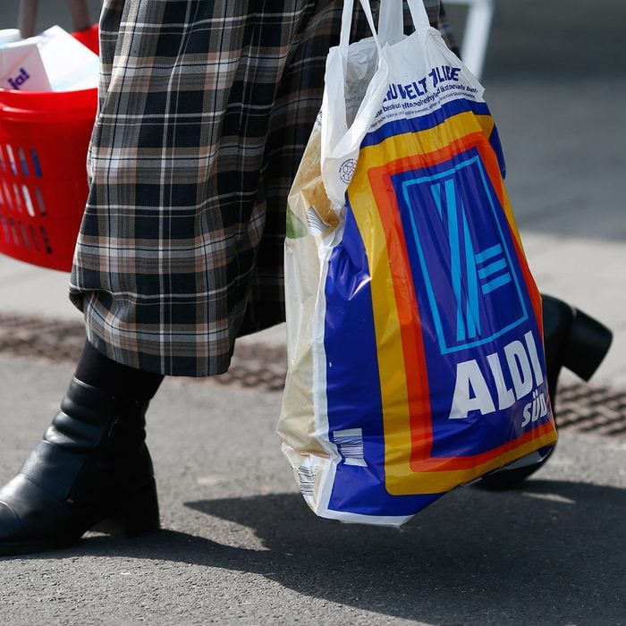 RUESSELSHEIM, GERMANY - APRIL 8: A shopper carries a bag of groceries from an Aldi store on April 8, 2013 in Frankfurt, Germany. Aldi, which today is among the world’s most successful discount grocery store chains, will soon mark its 100th anniversary and traces its history back to Karl Albrecht, who began selling baked goods in Essen on April 10, 1913 and founded the Aldi name by shortening the phrase Albrecht Discount. His sons Karl Jr. and Theo expanded the chain dramatically, creating 300 stores by 1960 divided between northern and southern Germany, with Aldi Nord and Aldi Sued, respectively. Today the two chains have approximately 4,300 stores nationwide and have also expanded into other countries across Europe and the USA. Aldi Nord operates in the USA under the name Trader Joe’s. (Photo by Ralph Orlowski/Getty Images)