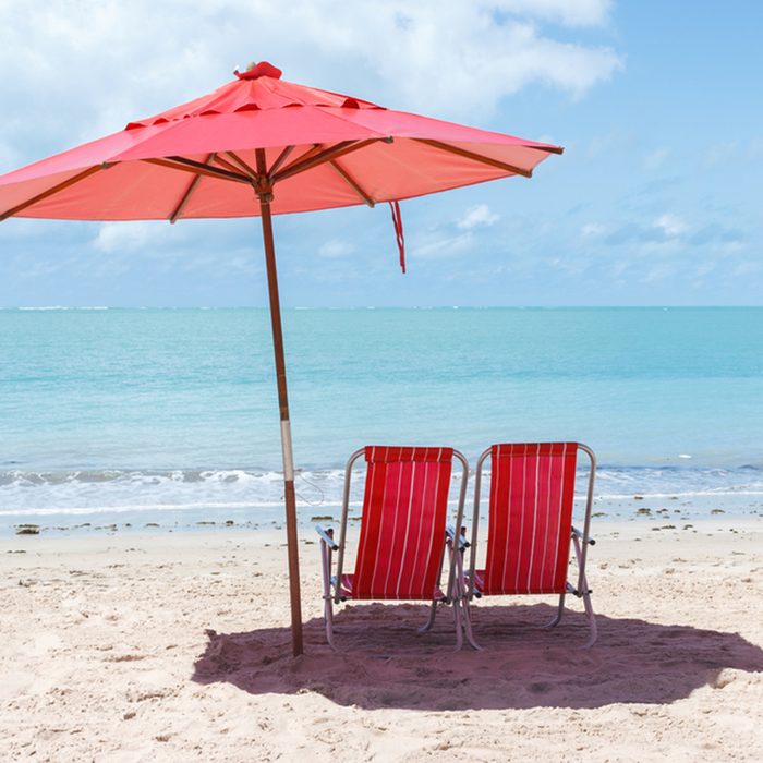 Pair of chairs and an umbrella on the beach of Ponta Verde, Maceio, Alagoas, northeast of Brazil