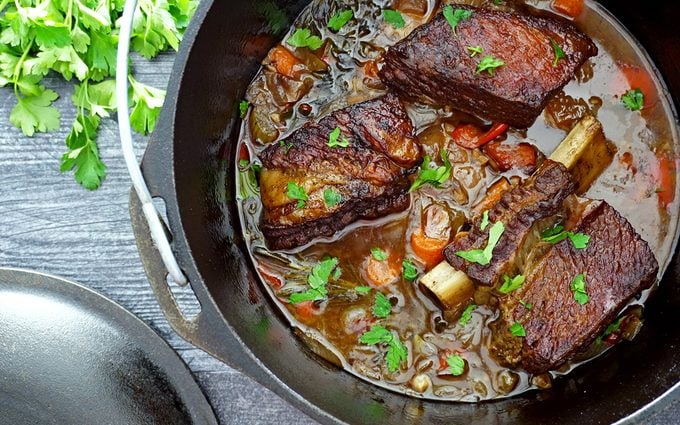 Dutch oven short ribs in cooking liquid after braising in the oven 1