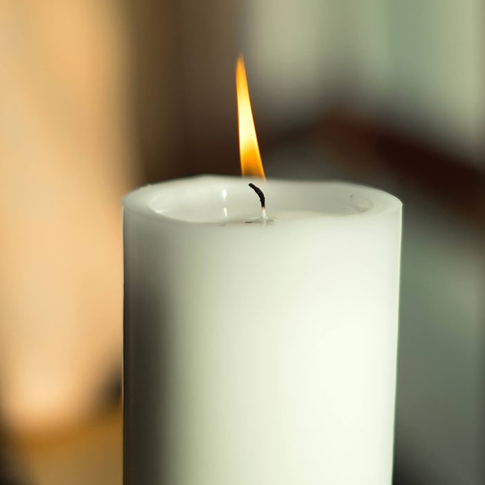 Large candle with a burning flame at christmastime; Shutterstock ID 405987730
